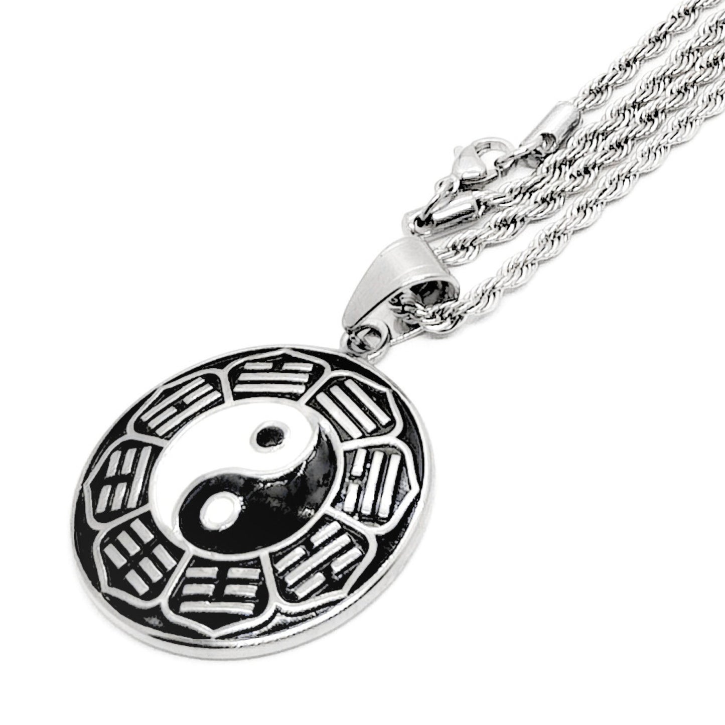 Silver yin-yang pendant necklace close-up: round disc yin-yang charm on chain
