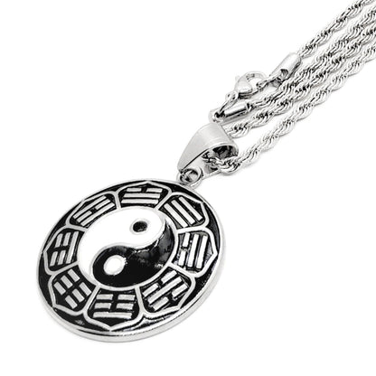 Silver yin-yang pendant necklace close-up: round disc yin-yang charm on chain