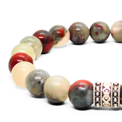 Close-up of men's natural stone beaded bracelet with red and cream beads plus silver-toned detail