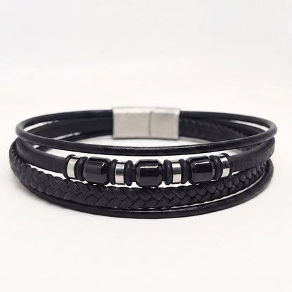 Black multi-strand leather bracelet with a silver magnetic clasp and glossy black beads with silver spacer rings, shown on a white background.