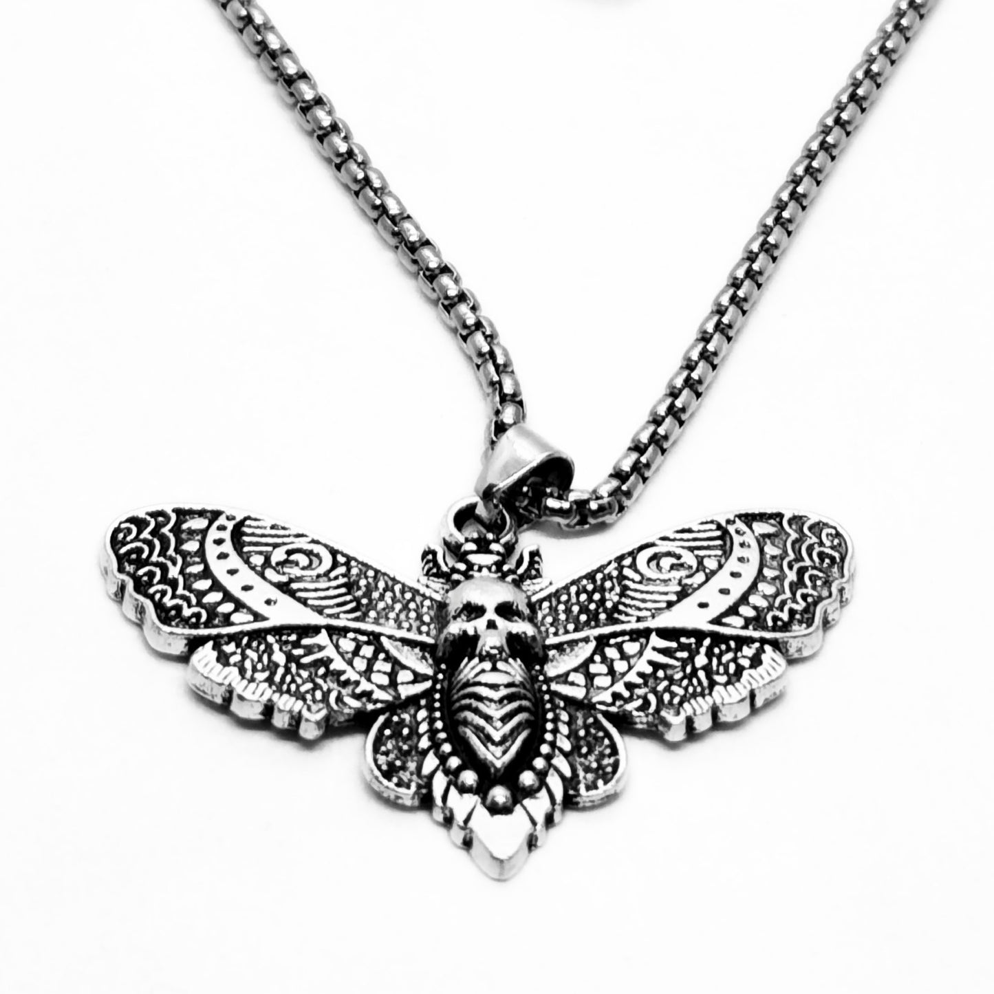 Silver-tone butterfly skull pendant necklace with ornate etched wings