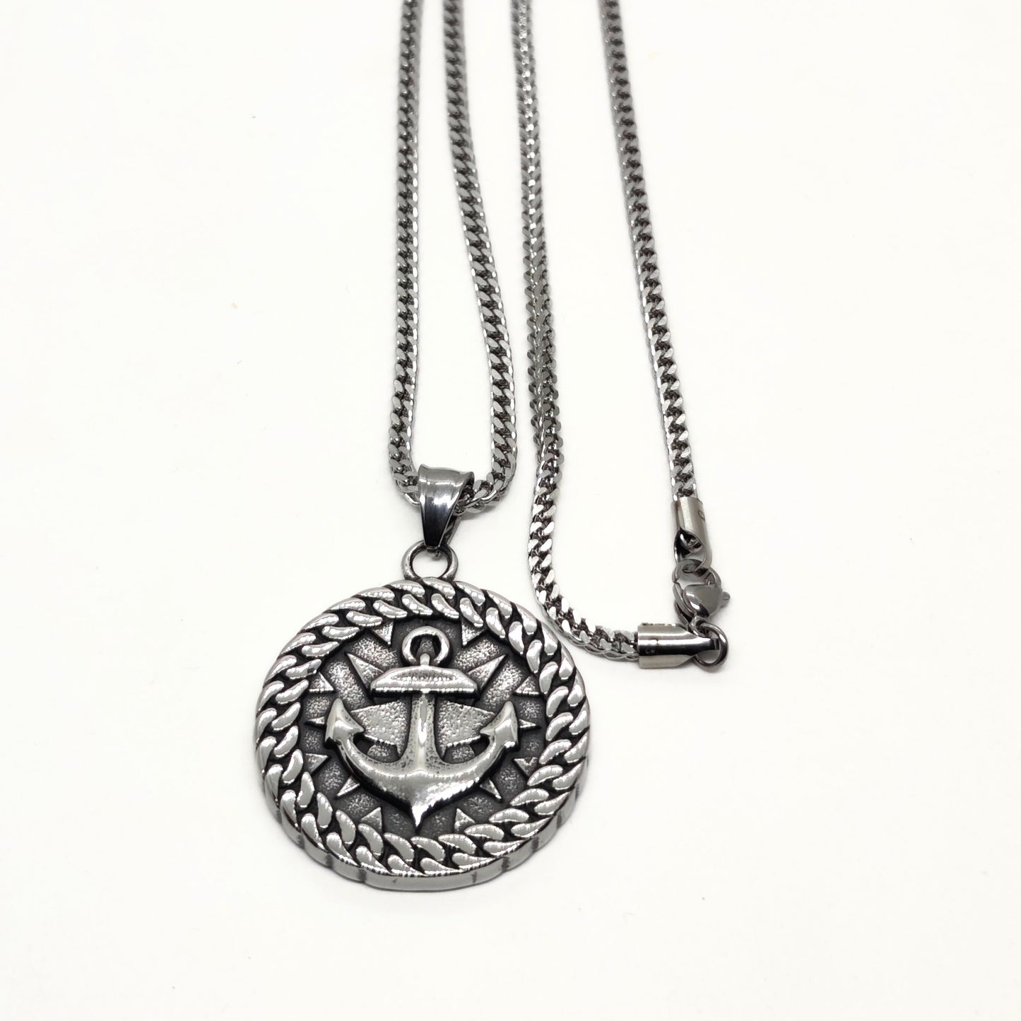 Silver steel necklace featuring an anchor pendant with a braided border design by Overpowered Accessories.