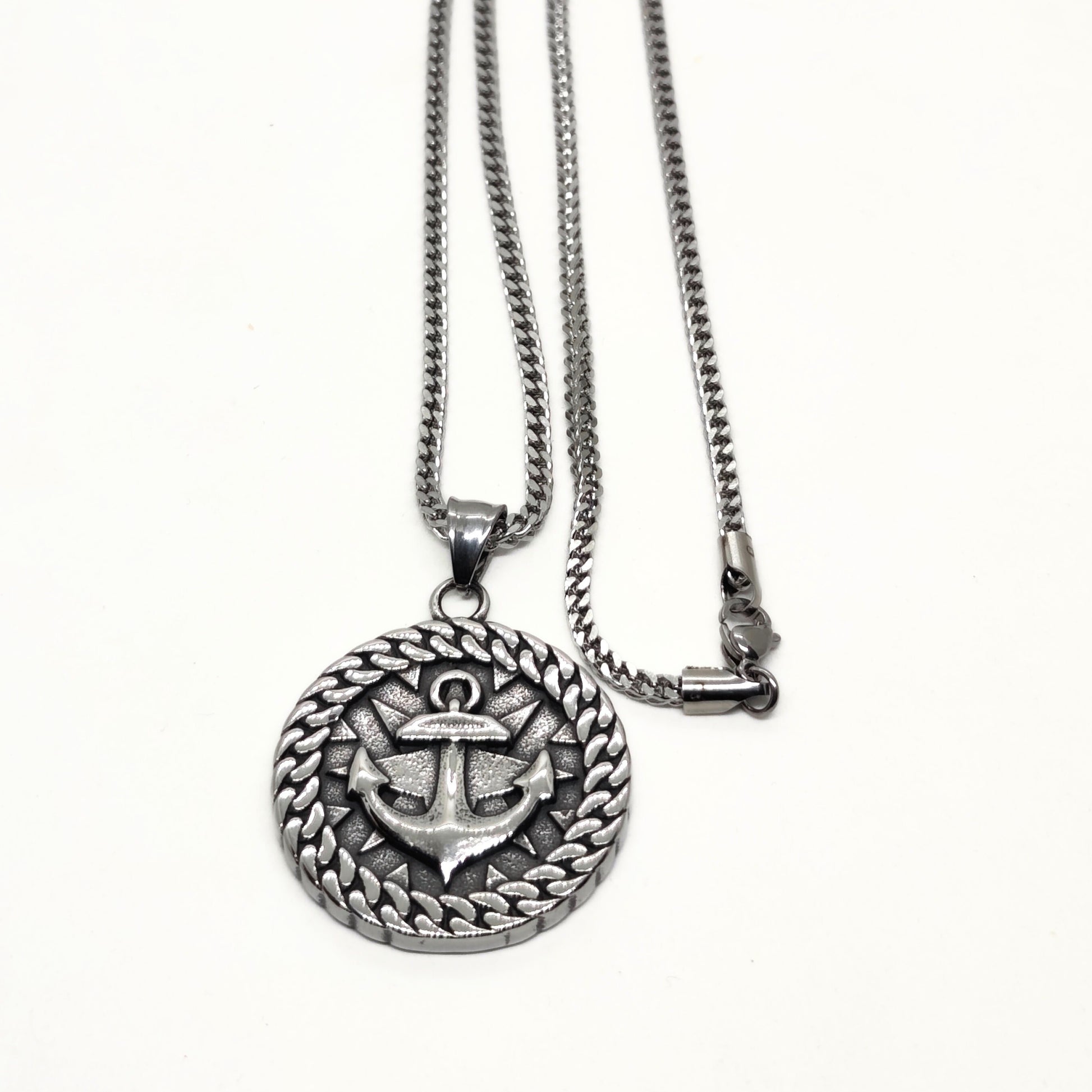 Silver steel necklace featuring an anchor pendant with a braided border design by Overpowered Accessories.