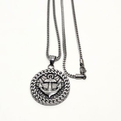 Silver steel necklace featuring an anchor pendant with a braided border design by Overpowered Accessories.