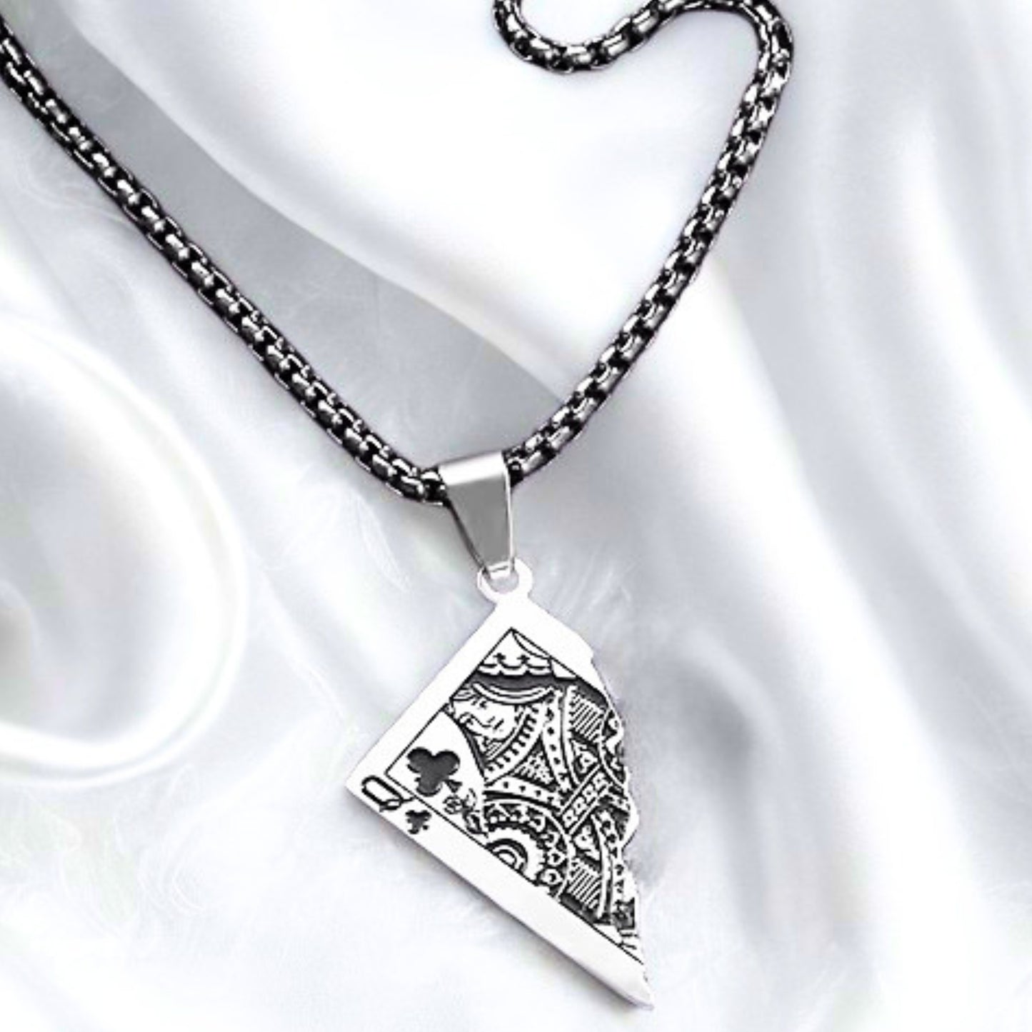 Silver PN-10 Queen Card Pendant necklace with intricate design, hanging from a black chain against a soft white background.