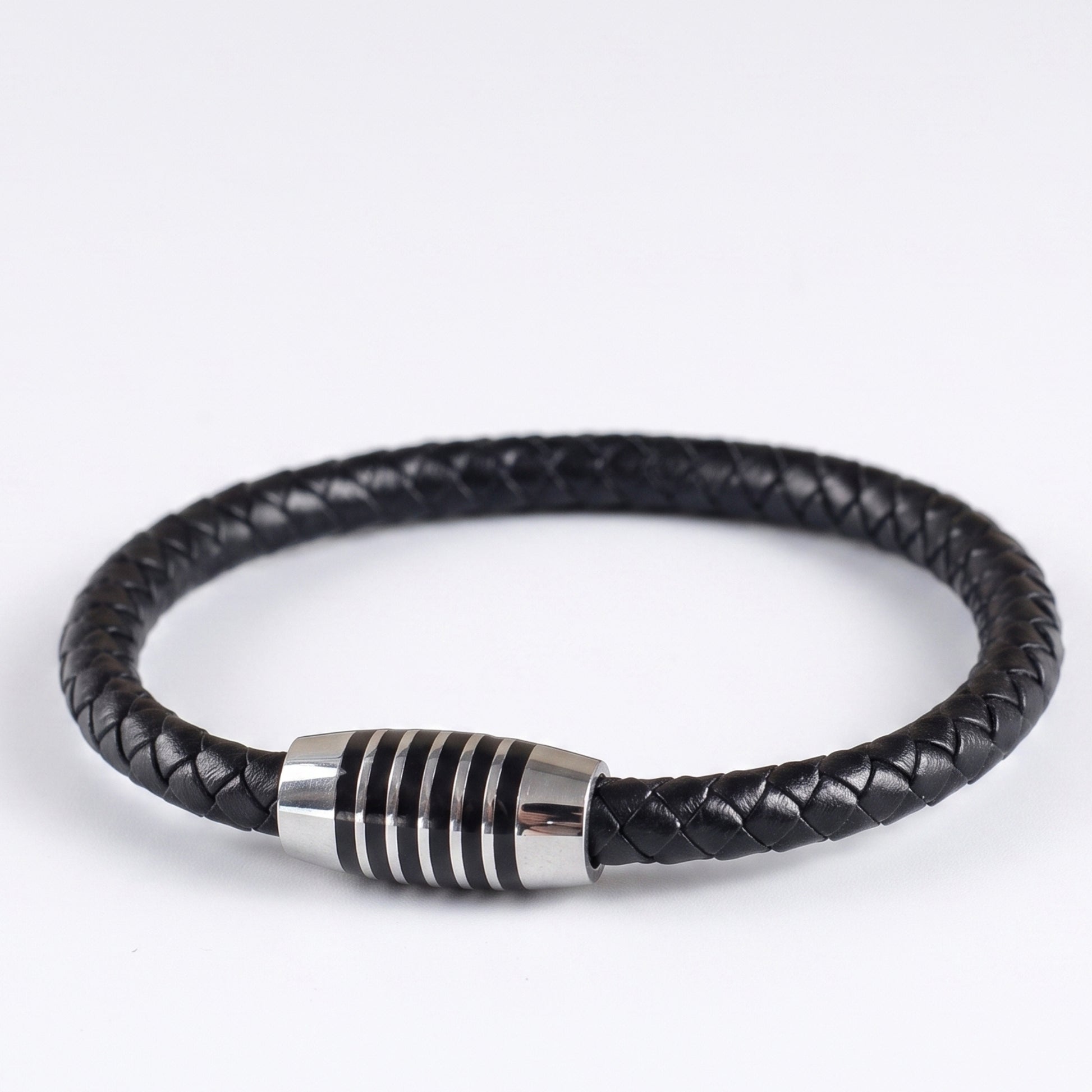 Black braided leather bracelet with silver-tone ringed clasp, side angle