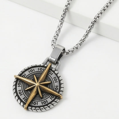 Two-tone compass pendant necklace with round dark dial, gold compass star, and silver chain