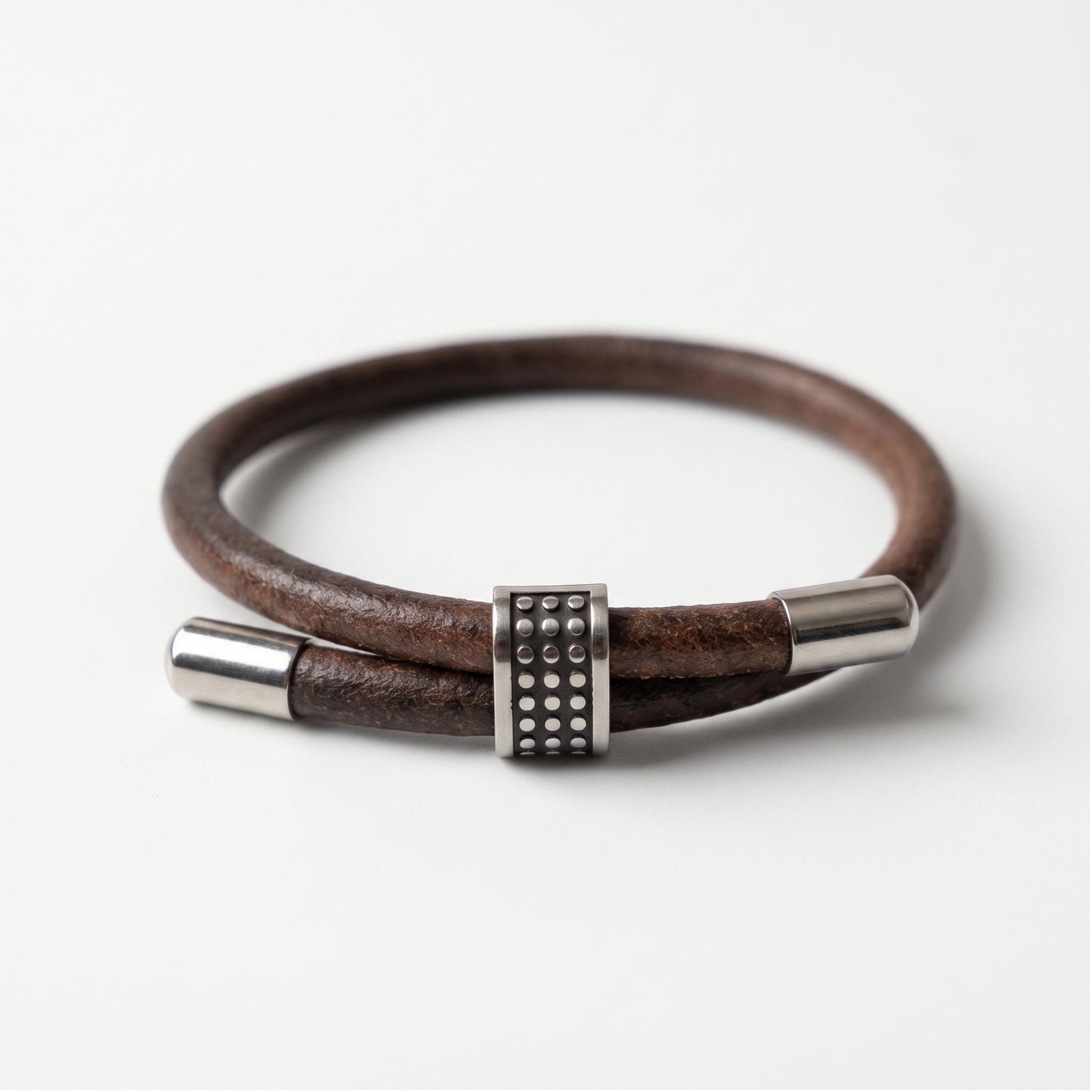 Men's brown leather bracelet with silver end caps and square studded clasp centerpiece