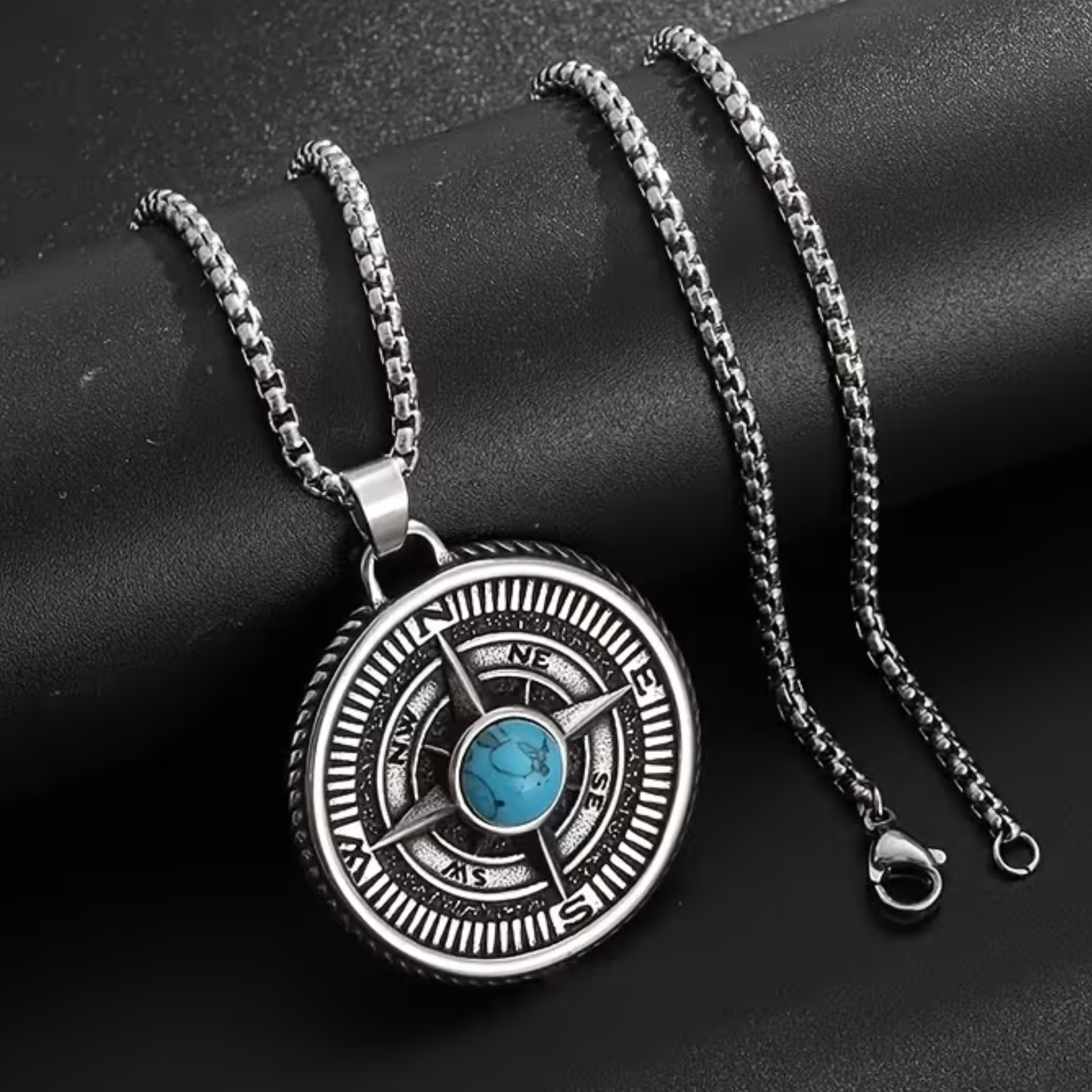 Compass pendant necklace with round silver-tone medallion and blue turquoise center stone