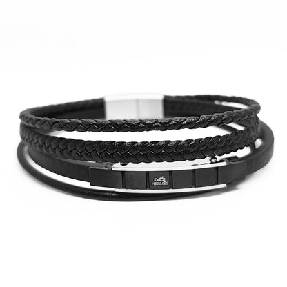 Black leather bracelet with braided cuff, smooth band stack, and silver-toned clasp