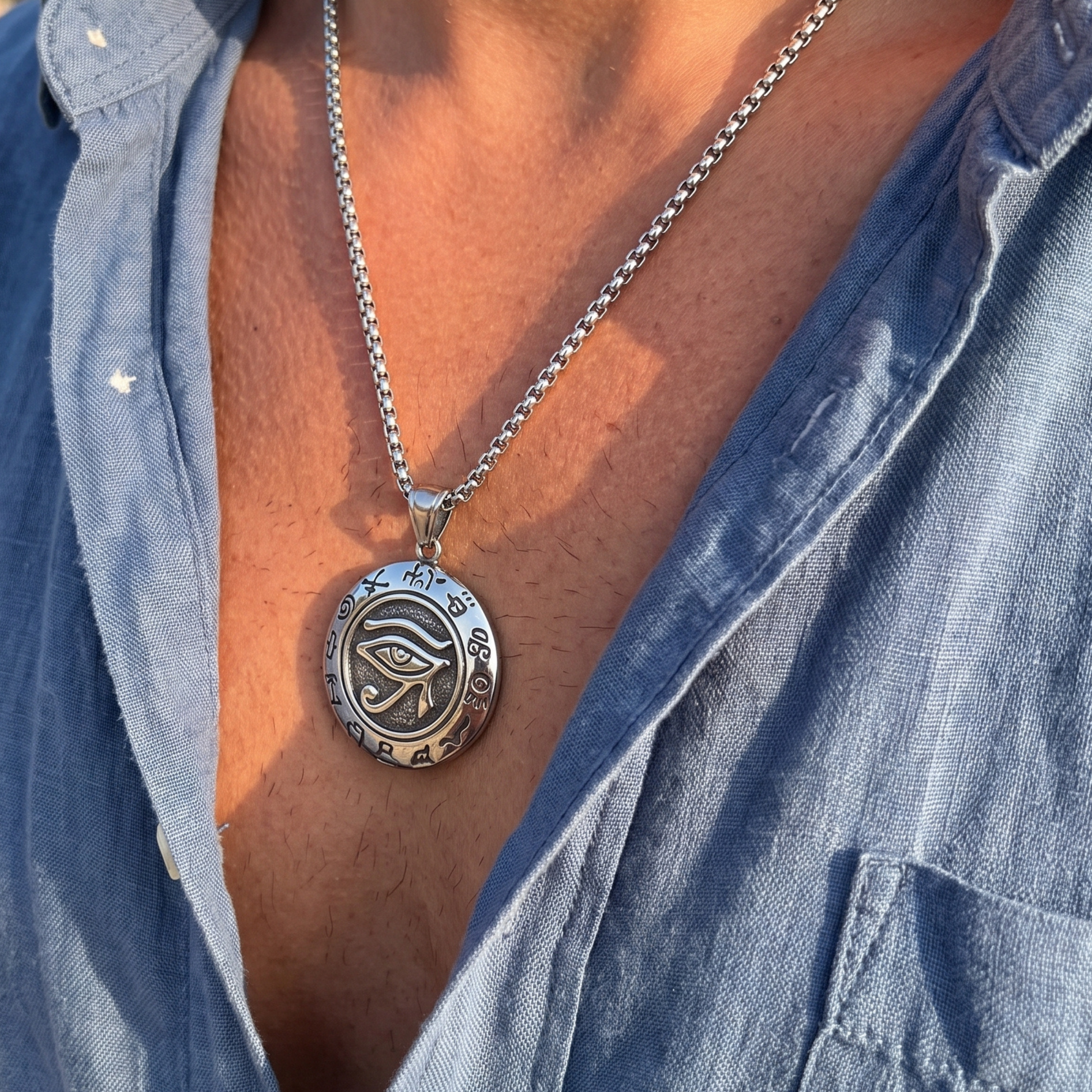 Oval eye symbol pendant necklace on blue shirt