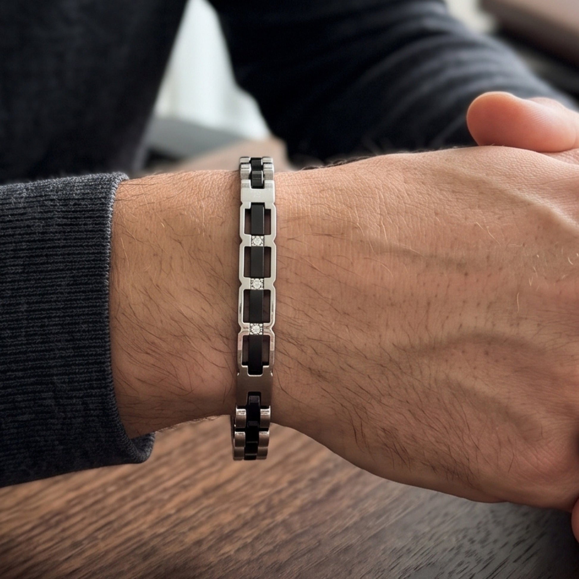 Worn stainless steel bracelet with silver and black link pattern on wrist