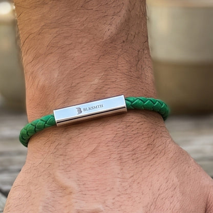 Green braided leather bracelet with silver bar clasp centered on wrist