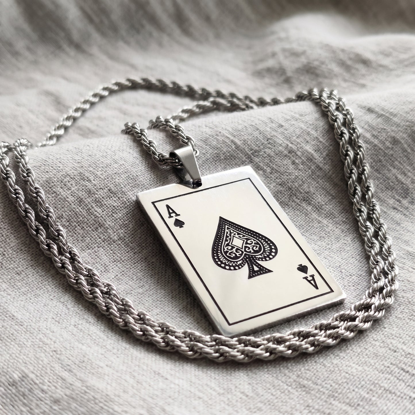 Square card pendant featuring Ace of Spades on layered twisted silver chains