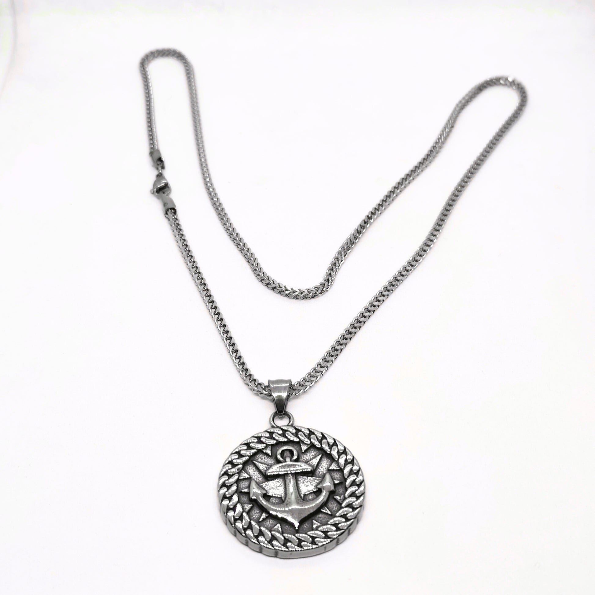 Silver steel necklace featuring an anchor pendant with a decorative circular design, from Overpowered Accessories.