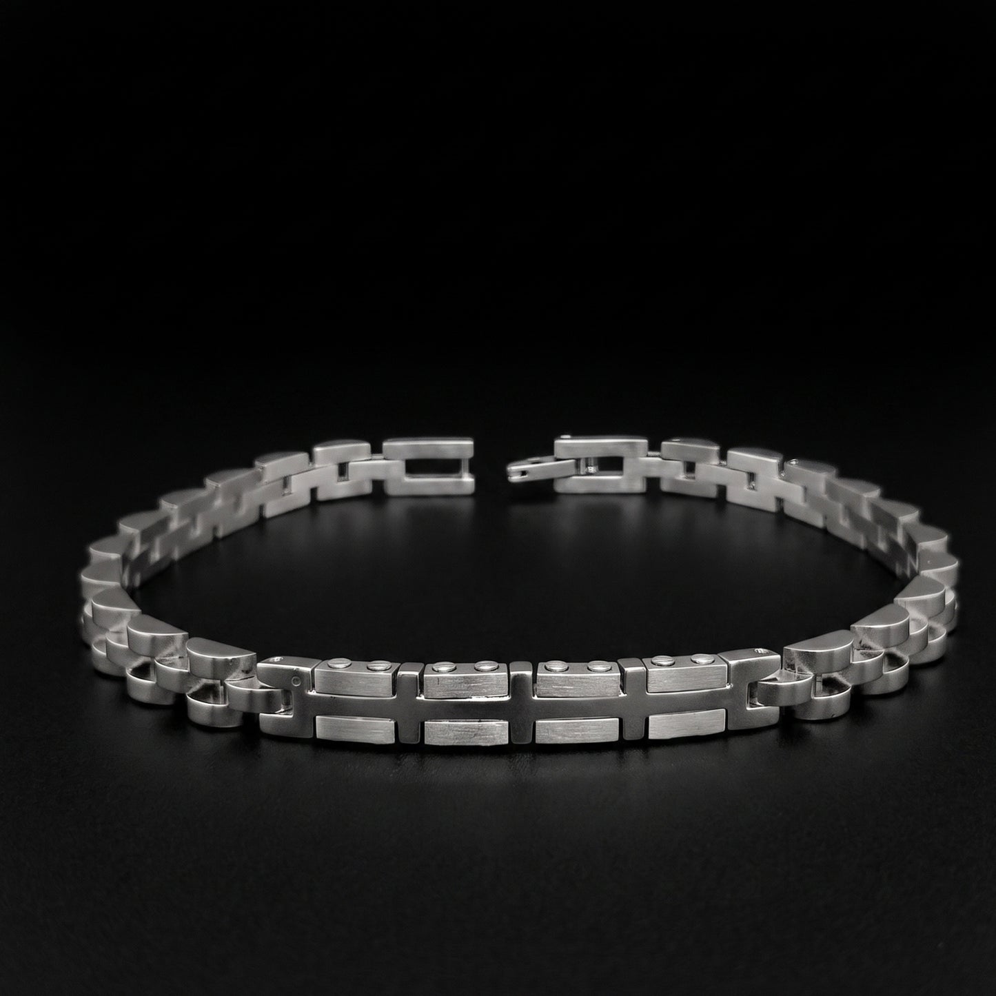 Silver stainless steel bracelet with geometric link pattern, open cuff view