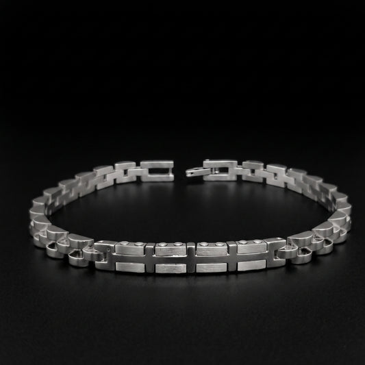 Silver stainless steel bracelet with geometric link pattern, open cuff view