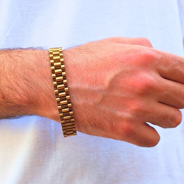 Gold-colored stainless steel B-35 bracelet worn on a man's wrist, showcasing a sleek, modern design.