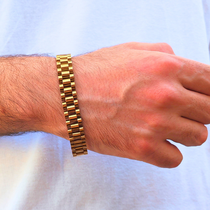 Gold-colored stainless steel B-35 bracelet worn on a man's wrist, showcasing a sleek, modern design.