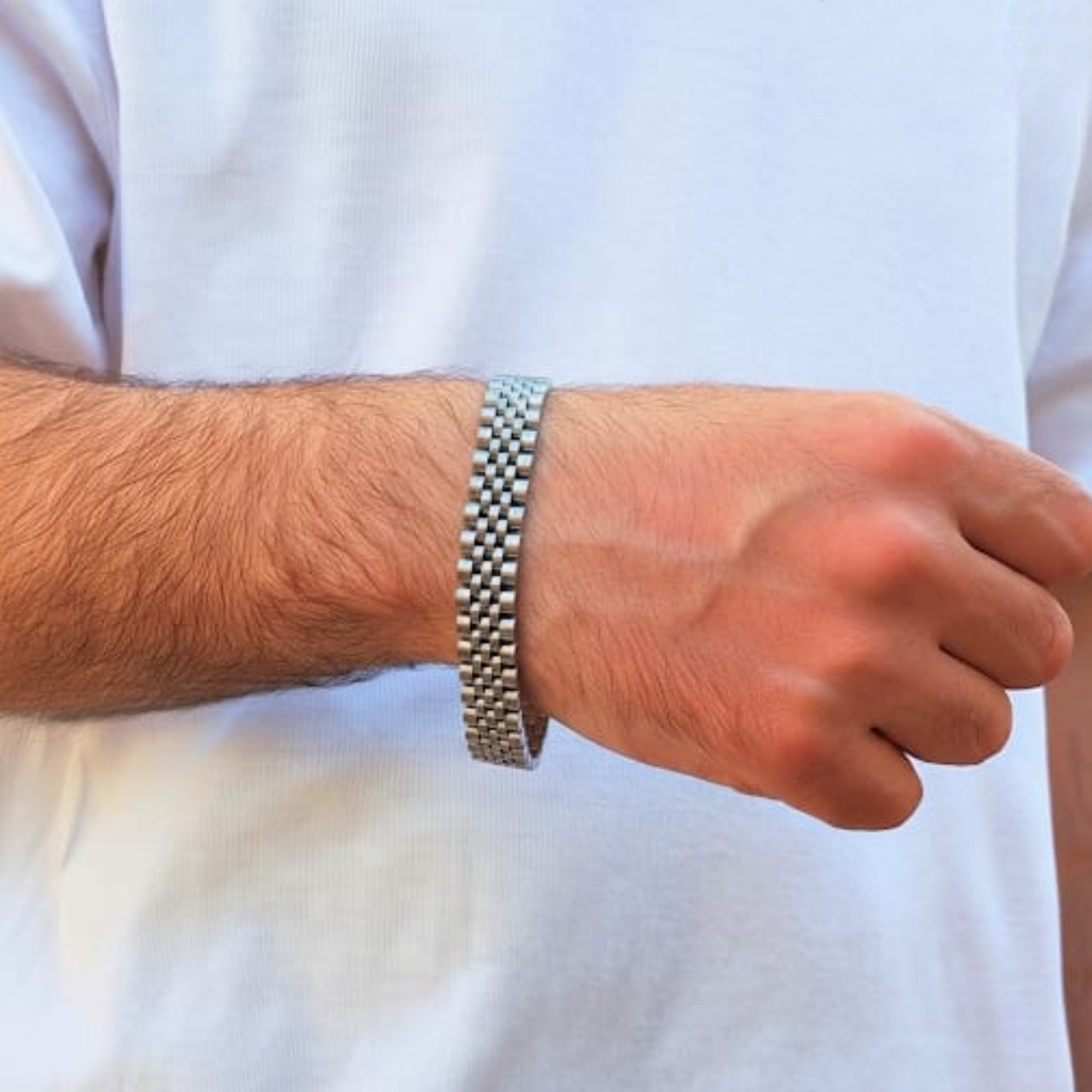 Elegant Silver Stainless Steel B-17 Bracelet worn on a man's wrist, showcasing a sleek, modern design.