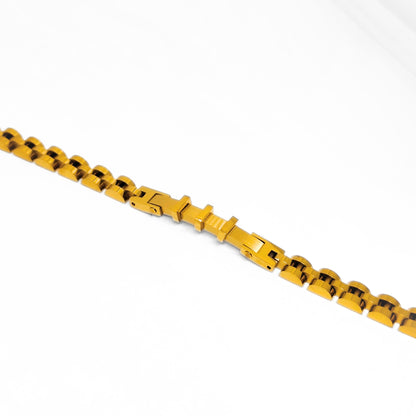 Gold stainless steel bracelet close-up showing box clasp and bar-link segments