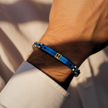 Blue and silver stainless steel men's bracelet B-113 from Overpowered Accessories, worn on a wrist with a light-colored shirt