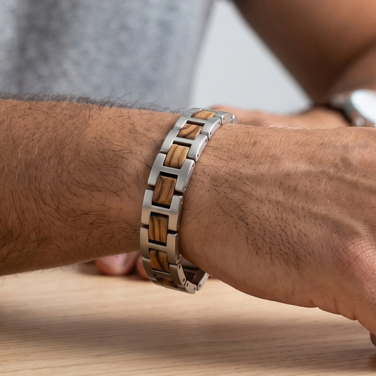 Zebrawood and stainless steel bracelet worn on wrist, close-up of link design, Overpowered Accessories