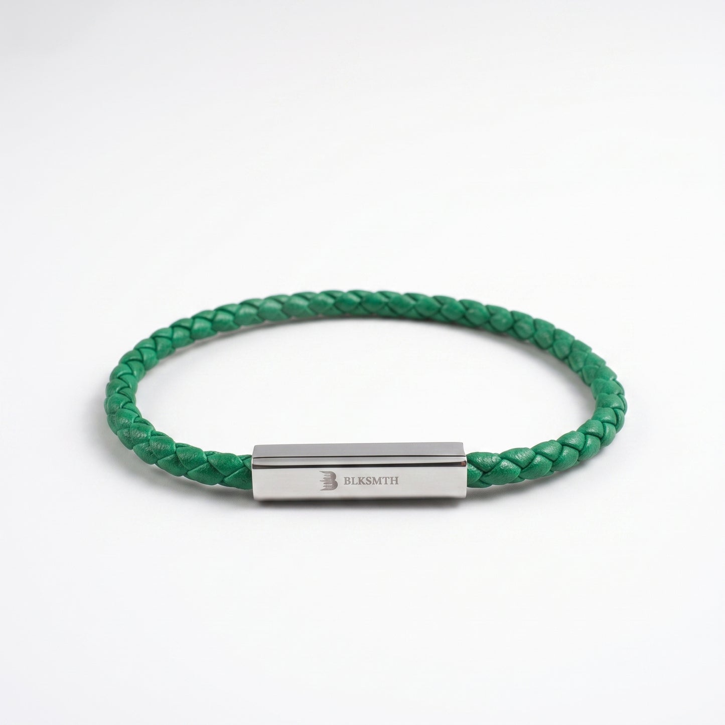 Green braided leather bracelet with rectangular silver clasp, flat lay view