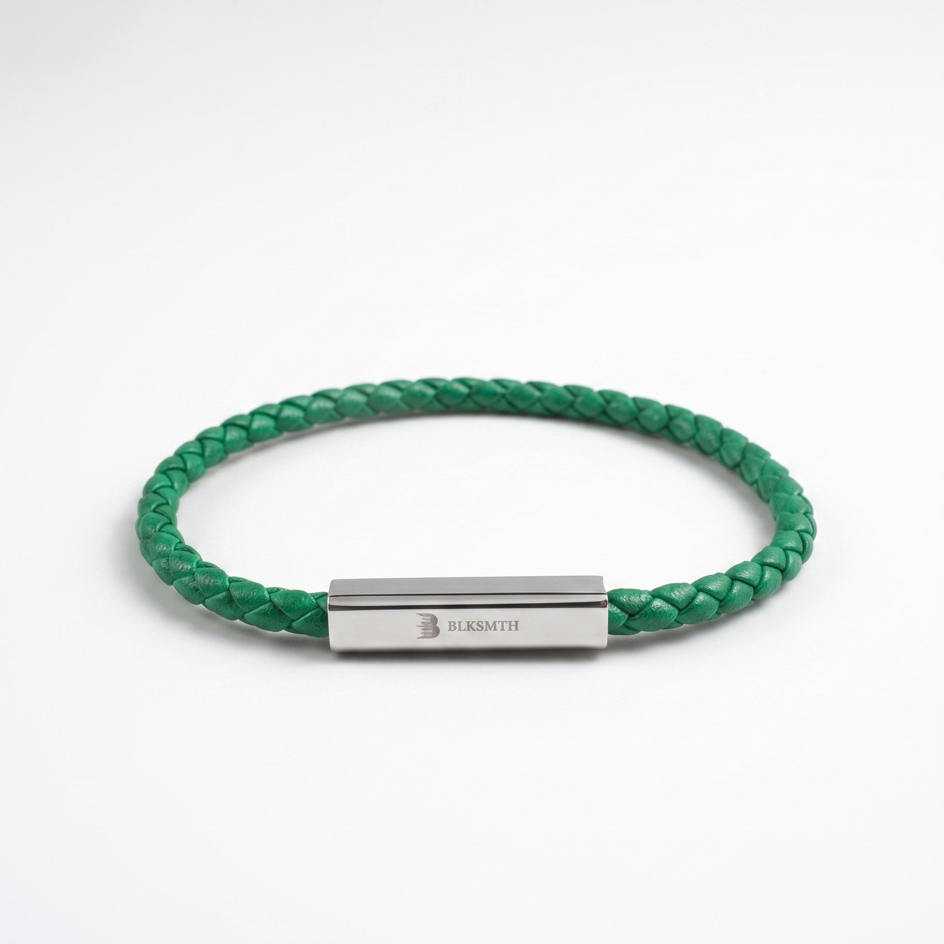 Green braided leather bracelet with rectangular silver clasp, flat lay view