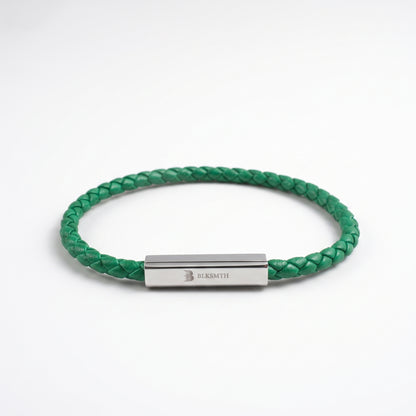 Green braided leather bracelet with rectangular silver clasp, flat lay view
