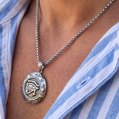 Small oval eye pendant necklace with silver chain, close-up