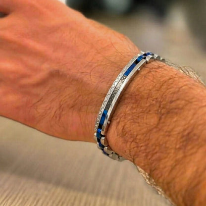 Two-tone silver and blue stainless steel B-39 bracelet worn on a man's wrist, showcasing a sleek design and modern style.