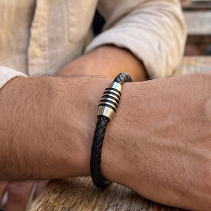 Black leather bracelet with braided texture and silver ringed metal clasp