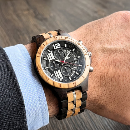 Men's wood sport watch on wrist, black dial with bold numerals and red second hand.