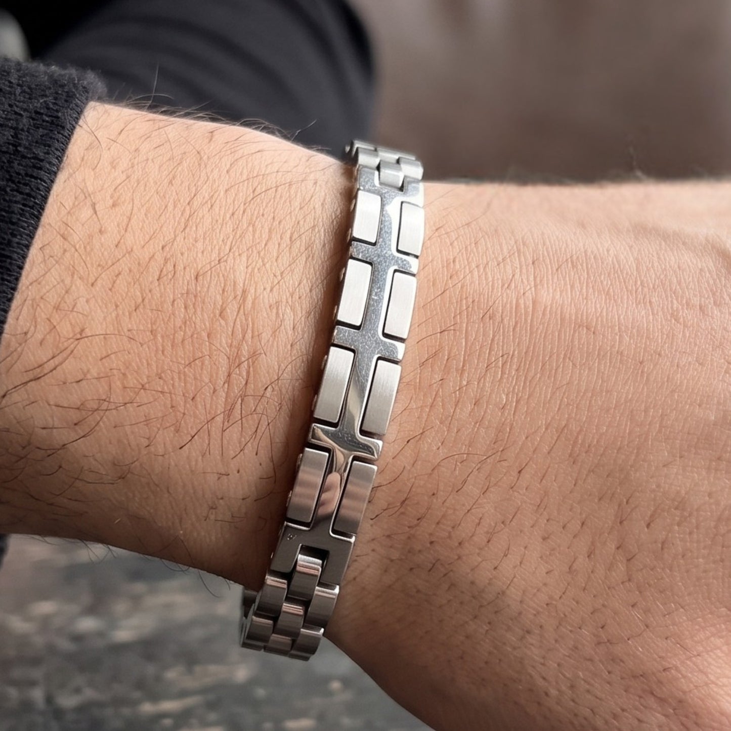 Silver stainless steel bracelet with cross-like panel on wrist