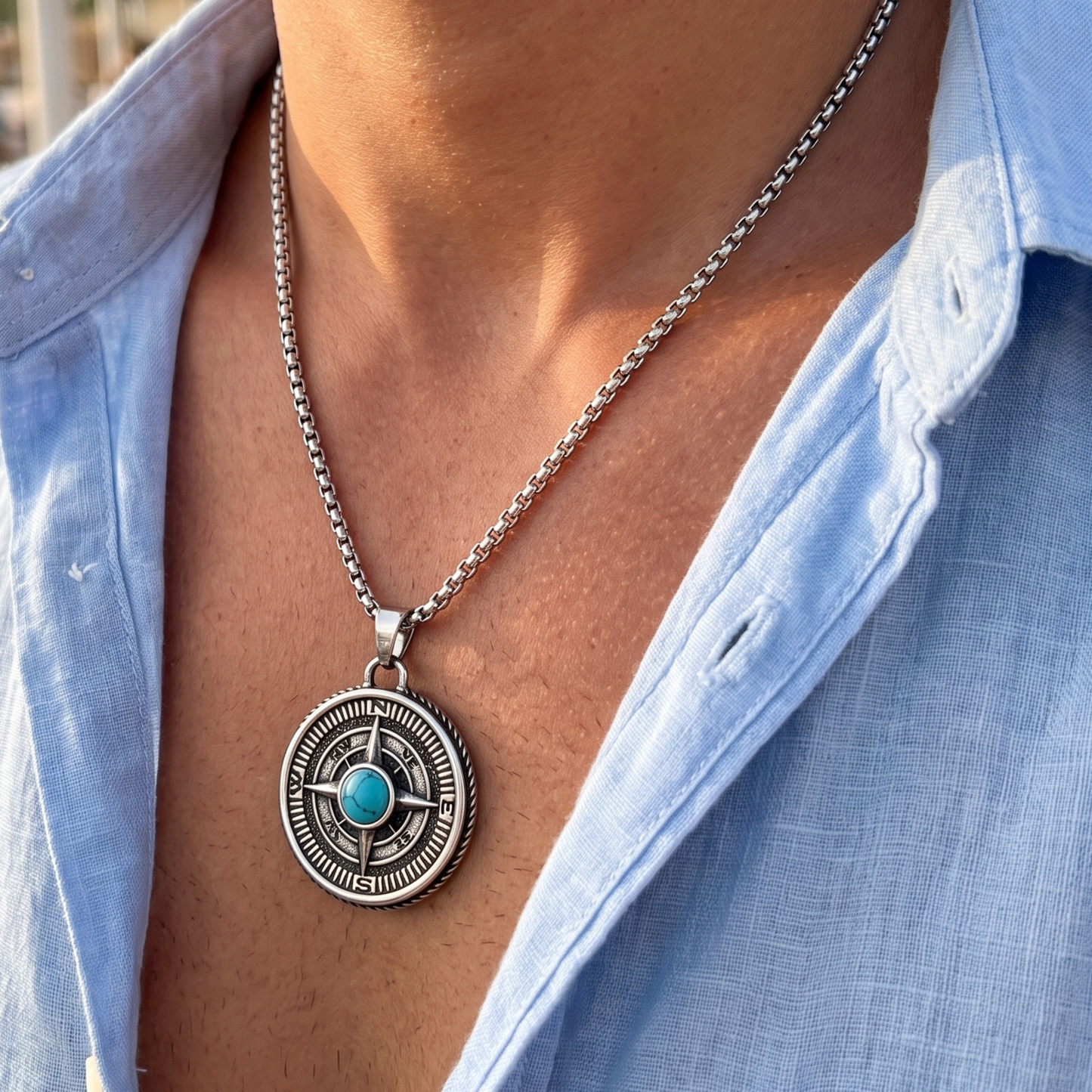 Round compass-style pendant necklace on silver chain with blue turquoise cabochon center