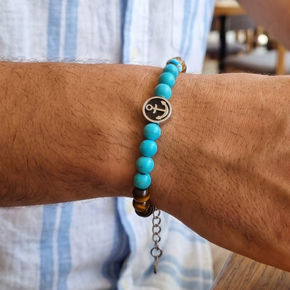 Men's tiger eye and turquoise anchor bracelet worn on wrist with round anchor charm