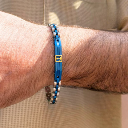 Blue and silver stainless steel men's bracelet B-113 by Overpowered Accessories, featuring an anchor design, worn on a wrist.