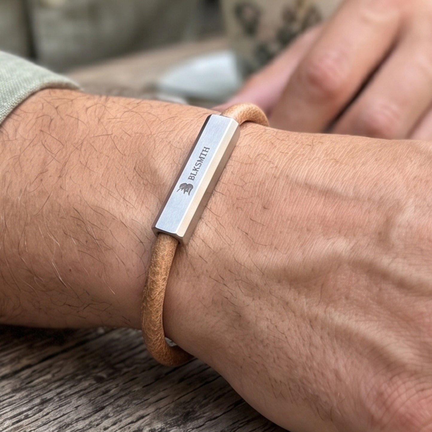 Men's beige-brown leather bracelet with engraved silver bar on wrist