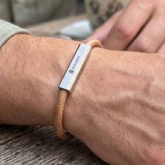Men's beige-brown leather bracelet with engraved silver bar on wrist