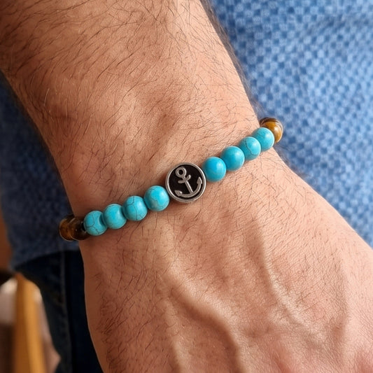 Men's turquoise and tiger eye bead anchor bracelet on wrist with silver anchor medallion