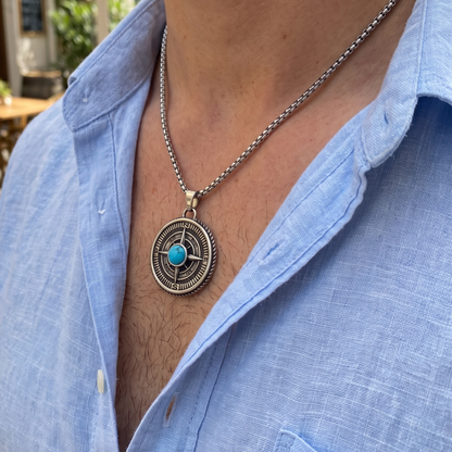 Round compass pendant necklace with blue turquoise stone set in silver-tone bezel