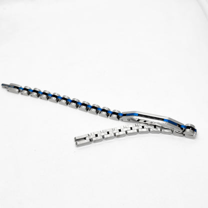 Stainless steel bracelet with blue accents and clasp laid flat on surface