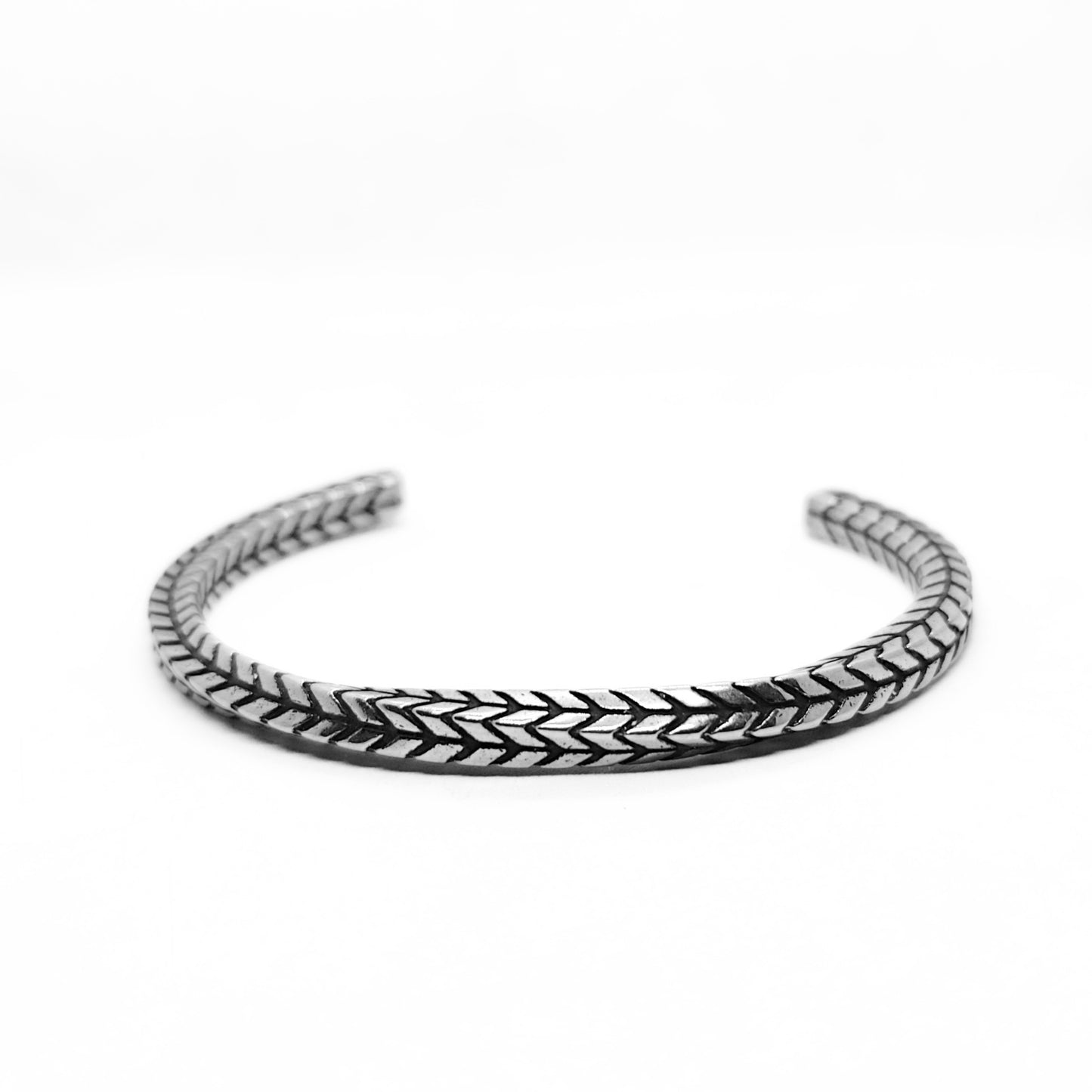 Silver stainless steel braided cuff bracelet, angled view of textured chain weave.