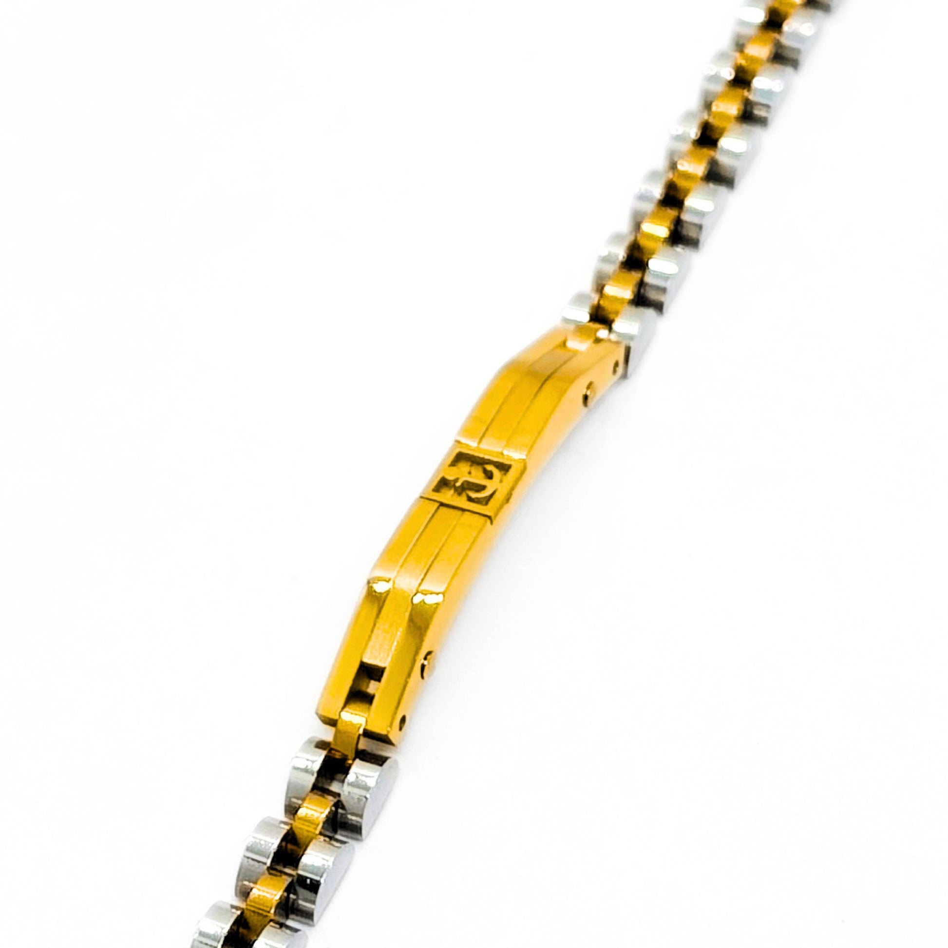 Close-up of two-tone anchor bracelet: gold center plate with anchor emblem on silver links