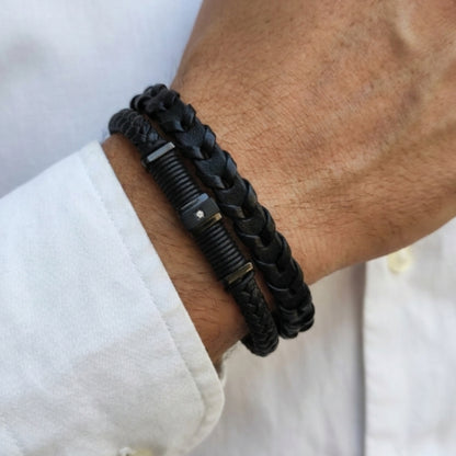 Black braided leather bracelet worn on wrist with rectangular magnetic clasp