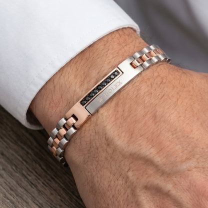 Silver and rose gold stainless steel bracelet with micro-zircon accents, worn on a wrist. Stylish men's accessory by Overpowe