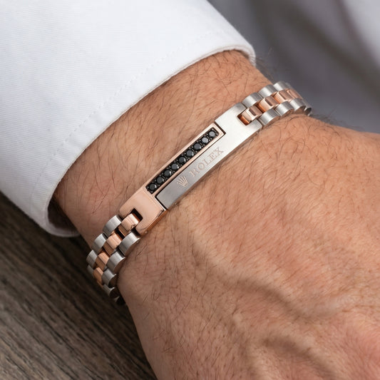 Silver and rose gold stainless steel bracelet with micro-zircon accents, worn on a wrist. Stylish men's accessory by Overpowe