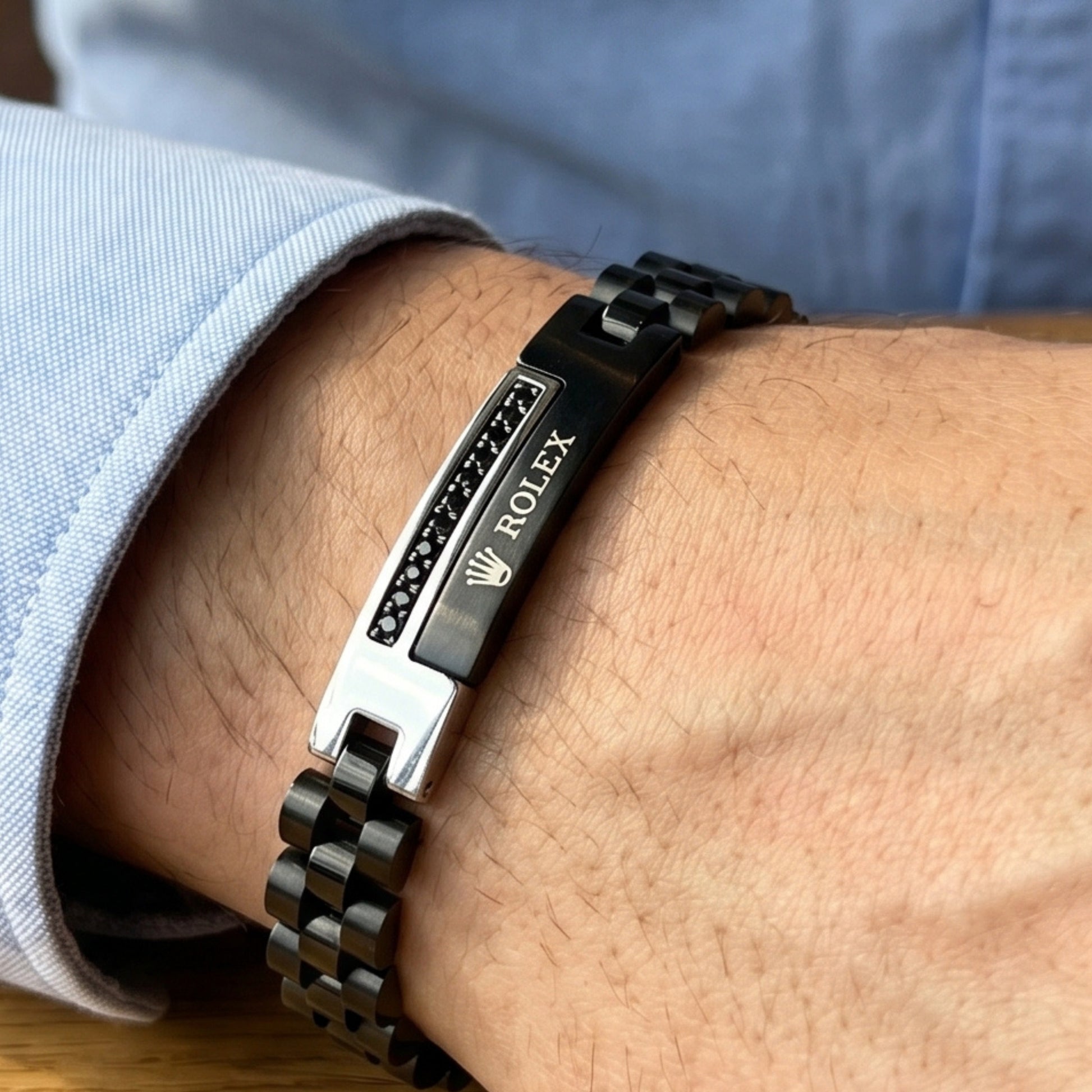 Silver and black stainless steel B-150 bracelet for men by Overpowered Accessories, featuring a sleek design and clasp.