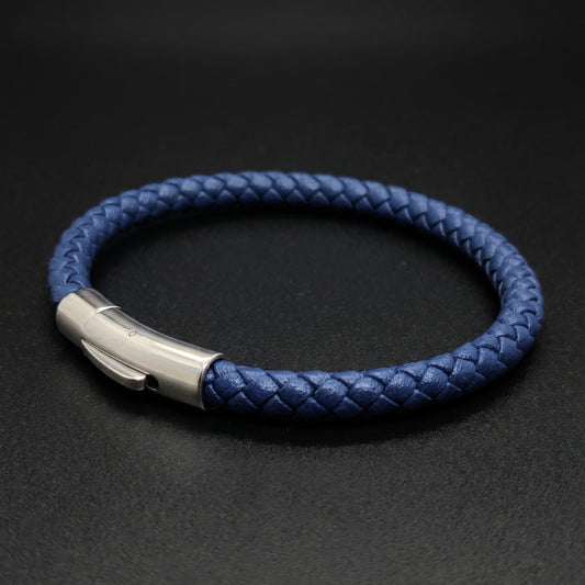Dark blue leather braided bracelet with silver clasp on dark background